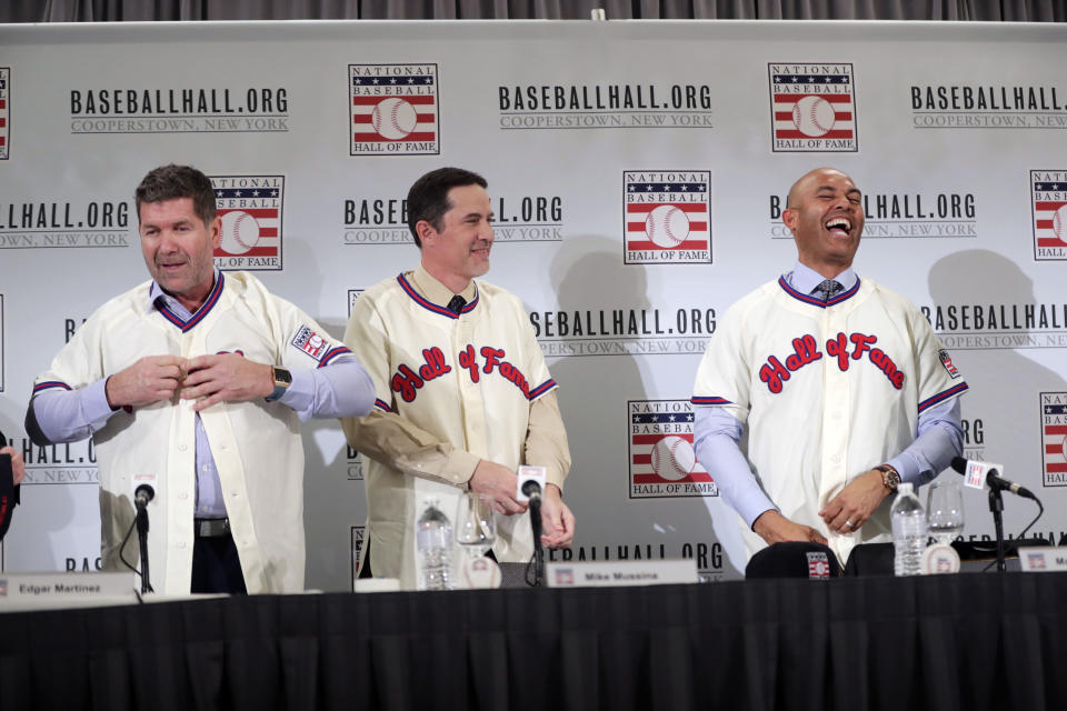 Baseball Hall of Fame inductees Edgar Martinez, left, Mike Mussina, center, and Mariano Rivera, right, put on jerseys during news conference Wednesday, Jan. 23, 2019, in New York. (AP Photo/Frank Franklin II)