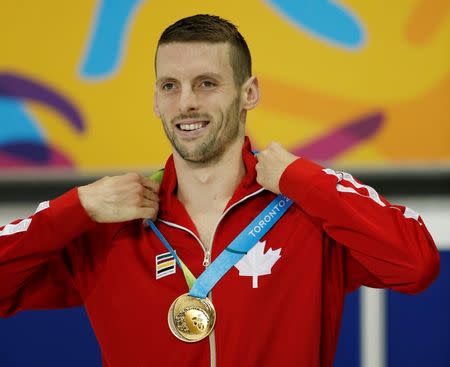 Ryan Cochrane of Canada adjusts his gold medal as he stands on the podium after the men's 400m freestyle final the 2015 Pan Am Games at Pan Am Aquatics UTS Centre and Field House. Erich Schlegel-USA TODAY Sports