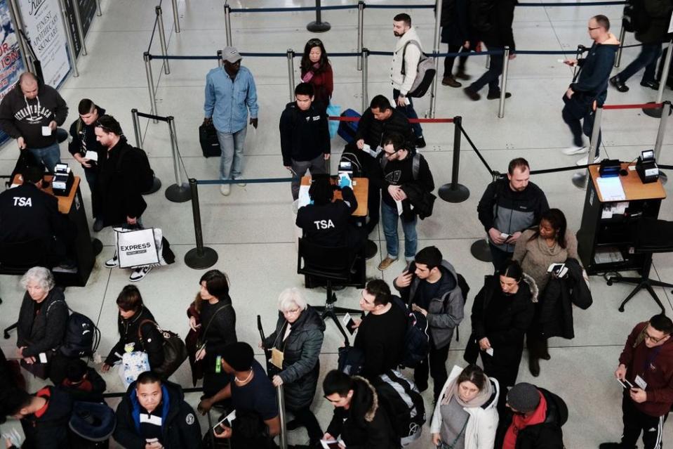 Passengers wait in a Transportation Security Administration line at JFK airport on January 09, 2019