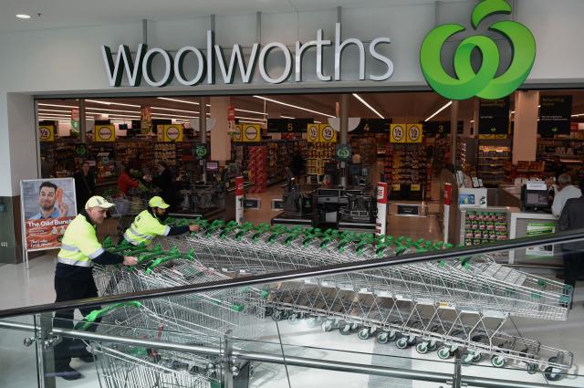 Workers push shopping trolleys at a Woolworths store in Sydney. Source: Getty Images