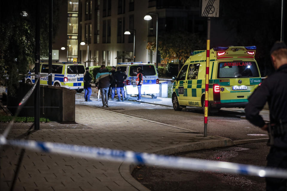 Ambulance and police stand at the scene where Swedish rapper Einar was shot to death, in Hammarby Sjostad district in Stockholm, early Friday, Oct. 22, 2021. An award-winning 19-year-old Swedish rapper was shot to death in southern Stockholm in an incident that media reports on Friday suggested could be gang-related. The rapper Einar was struck by several bullets in the Hammarby suburb south of central Stockholm and died on the spot late Thursday, police spokesman Ola Osterling told the Swedish news agency TT. (Christine Olsson/TT via AP)