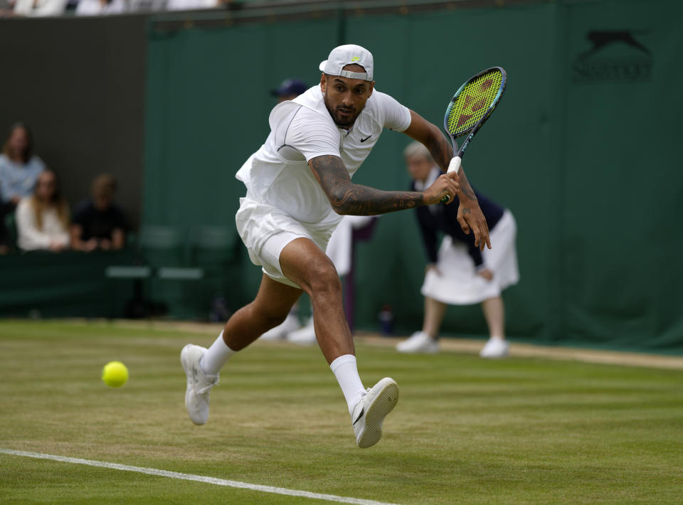 Australia's Nick Kyrgios returns to Serbia's Filip Krajinovic, in a second round men's single match on day four of the Wimbledon tennis championships in London, Thursday, June 30, 2022. (AP Photo/Alastair Grant)