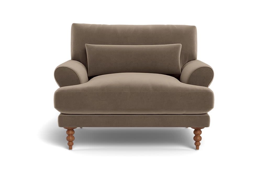 a brown couch with a cushion