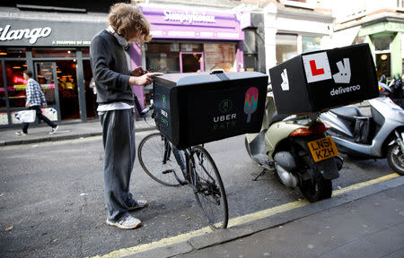 FILE PHOTO: An UberEATS food delivery courier waits for an order in London, Britain September 7, 2016. REUTERS/Neil Hall/File Photo