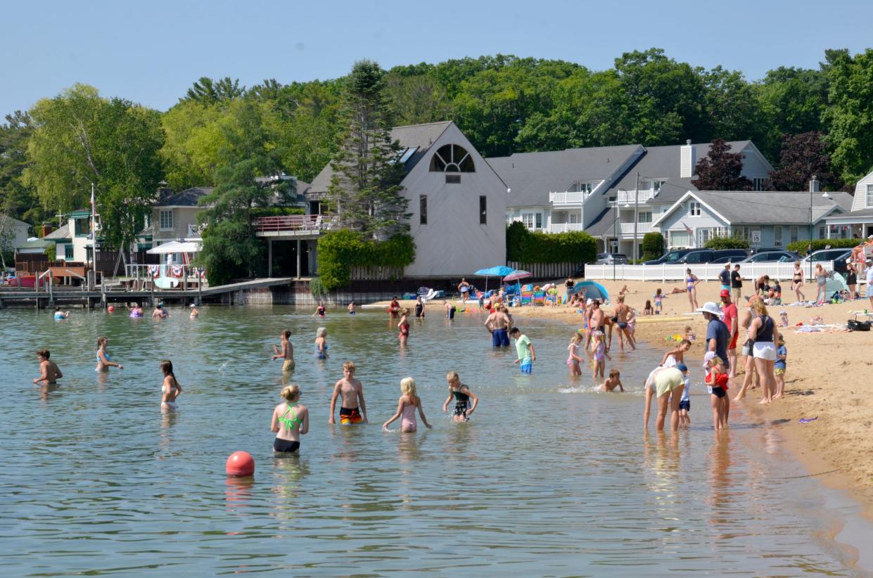 People enjoy a sunny morning at the Zorn Park City Beach in Harbor Springs on Tuesday, July 4, 2023.