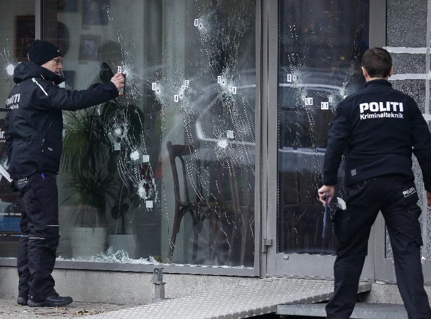 FILE - In this Sunday, Feb. 15, 2015 file photo, a police investigator works at the scene of a shooting at a free speech event in Copenhagen. The head of Denmark's intelligence agency announced his resignation on Wednesday May 6, 2015, hours before a government report was released criticizing some parts of the police response to the two fatal shooting attacks in Copenhagen in February. (Jens Dresling/Polfoto via AP) DENMARK OUT