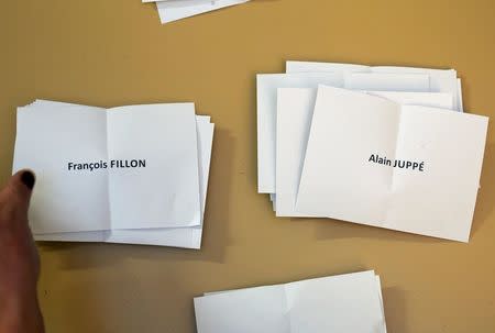 An official counts ballots for candidates in the first round vote of the French center-right presidential primary election, in a polling station in Strasbourg, France, November 20, 2016. REUTERS/Vincent Kessler