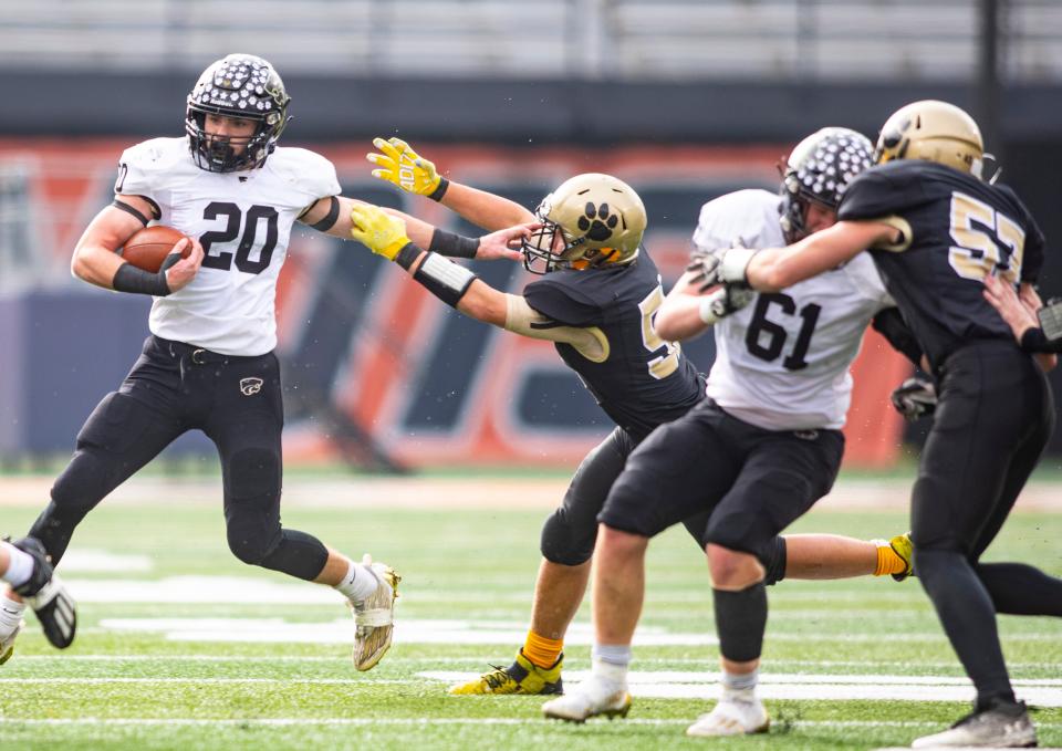 Lena-Winslow's Gunar Lobdell breaks a tackle on Friday, Nov. 25, 2022, at University of Illinois in Champaign.