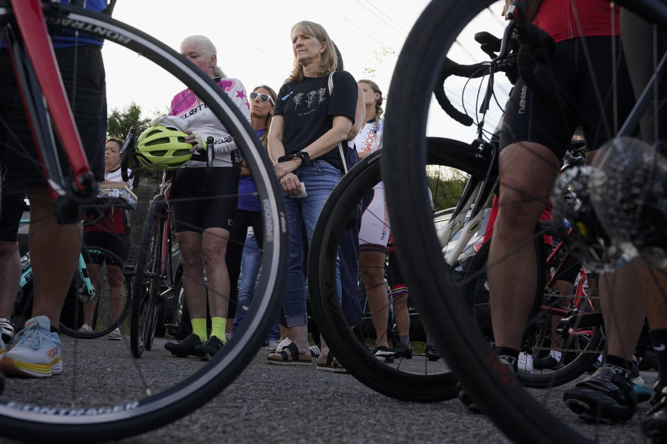 Kim Milligan, center, listens as a group of cyclists gather to remember her daughter, Alyssa, before a memorial ride in her honor Tuesday, Sept. 12, 2023, in Mount Juliet, Tenn. Milligan's daughter was struck and killed by a pickup truck while cycling with a friend the previous week. (AP Photo/George Walker IV)