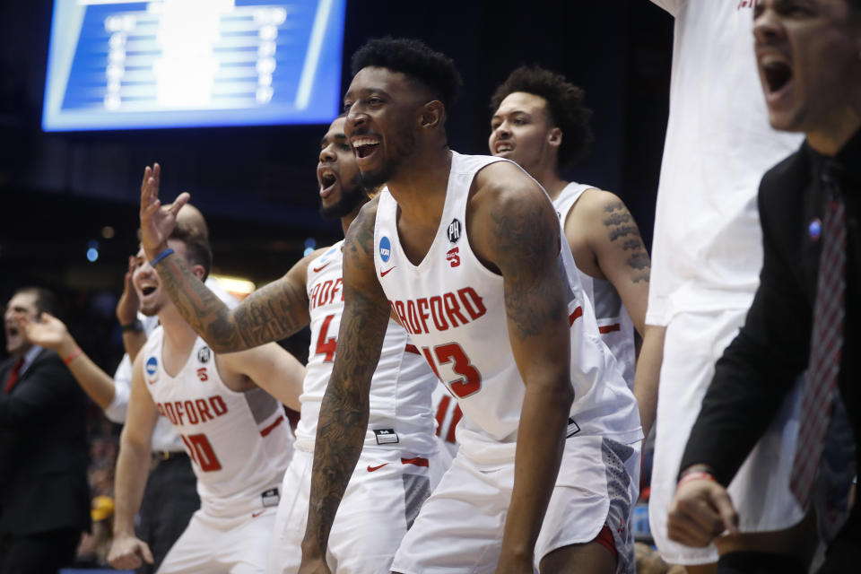 Radford’s Leroy Butts IV (13) and the Radford bench react during the second half of a First Four game of the NCAA men’s college basketball tournament against LIU Brooklyn, Tuesday, March 13, 2018, in Dayton, Ohio. Radford won 71-61. (AP Photo/John Minchillo)