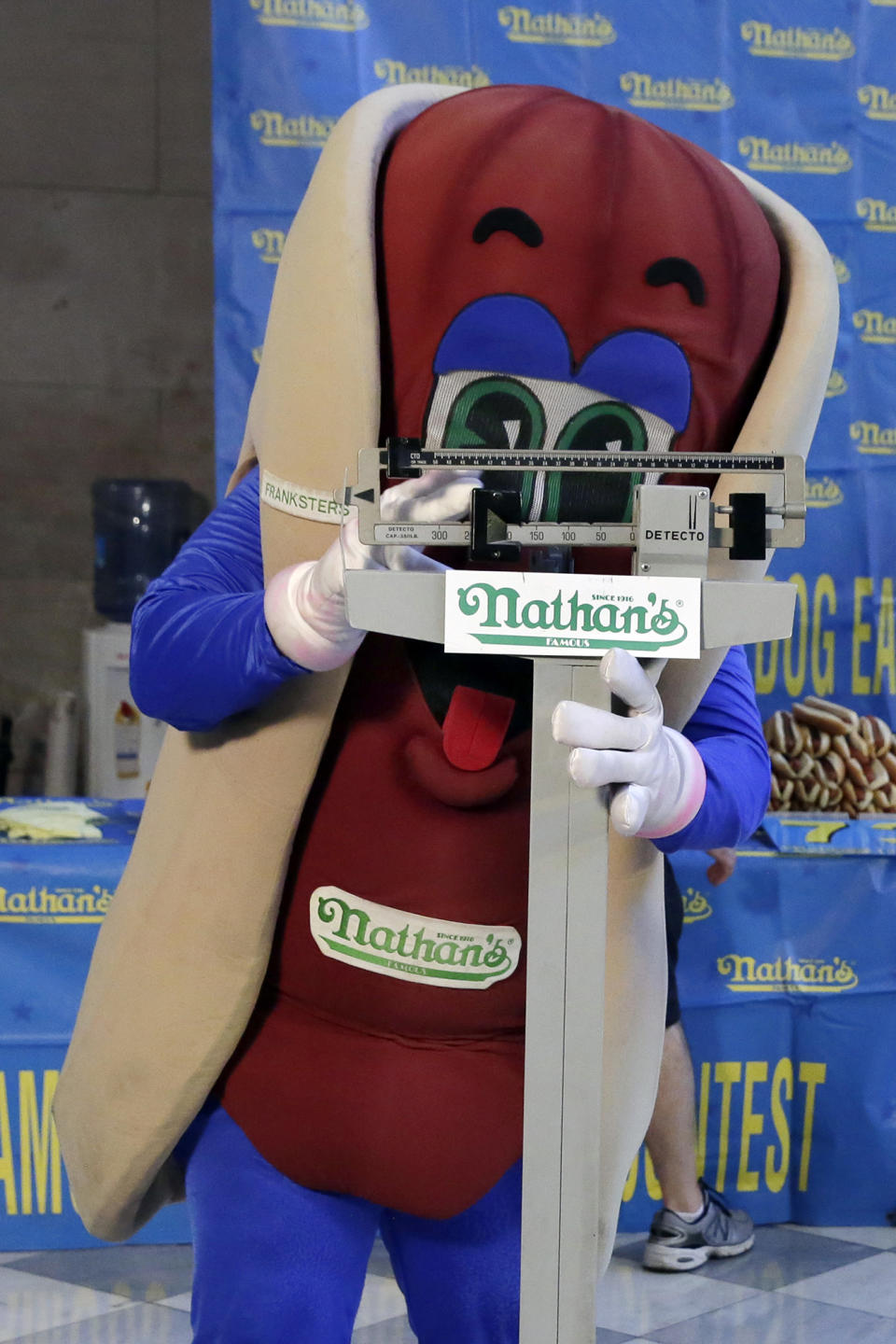 <p>The Nathan’s character poses for photos on the scale during the weigh-in for the 2017 Nathan’s Hot Dog Eating Contest, in Brooklyn Borough Hall, in New York, Monday, July 3, 2017. (AP Photo/Richard Drew) </p>