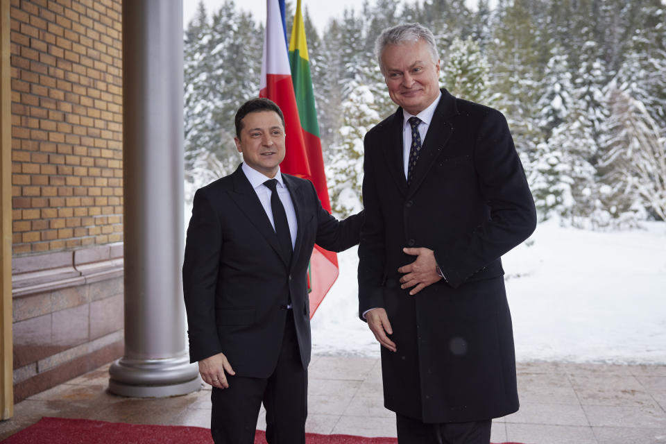 Ukrainian President Volodymyr Zelenskyy, left, and Lithuania's President Gitanas Nauseda greet each other before their meeting at the presidential residence in Ivano-Frankivsk region, 430 kilometers (270 miles) southwest of the capital, Kyiv, Monday, Dec. 20, 2021. (Ukrainian Presidential Press Office via AP)