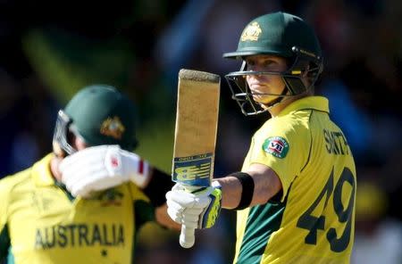 Australia's batsman Steve Smith acknowledges his 50 runs during his Cricket World Cup semi-final match against India in Sydney, March 26, 2015. REUTERS/Steve Christo