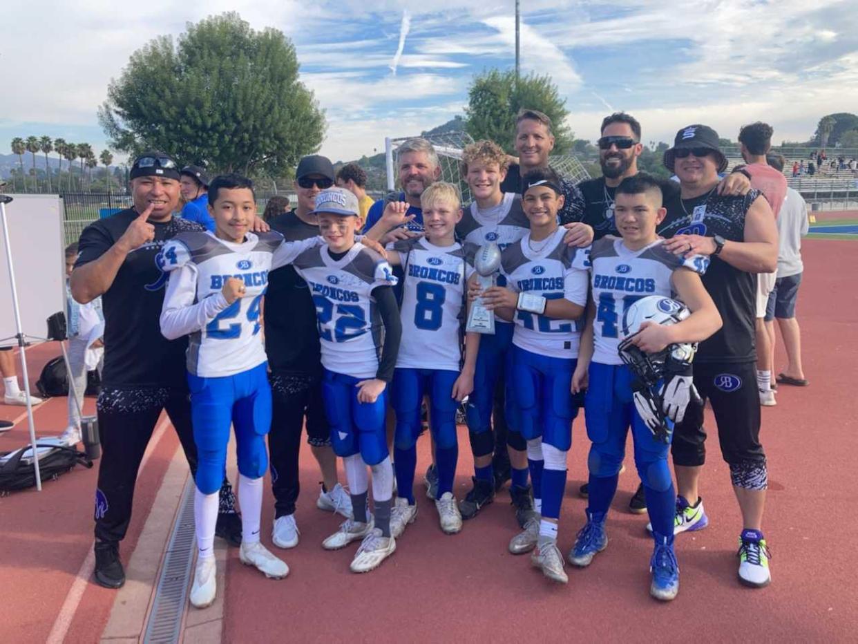 Rams safety Eric Weddle (second from right, back row) helped coach his son's 12U team, the Rancho Bernardo Broncos, to a championship this past fall. (Courtesy of Al Gamez)