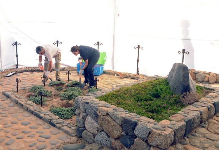 A photo released by the Chilean Judiciary Communications Office shows members of the Medical Legal Service digging up the tomb of Chilean poet Pablo Neruda in Isla Negra, on April 7, 2013