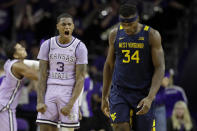 Kansas State's DaJuan Gordon (3) celebrates a basket as he walks down the court with West Virginia's Oscar Tshiebwe (34) during the first half of an NCAA college basketball game Saturday, Jan. 18, 2020 in Lawrence, Kan. Kansas State won 84-68 (AP Photo/Charlie Riedel)