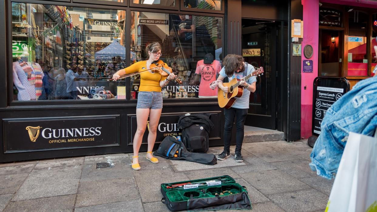 Dublin, JUL 1: Street artist performing music with violin and guitar on JUL 1, 2018 at Dublin, Ireland.