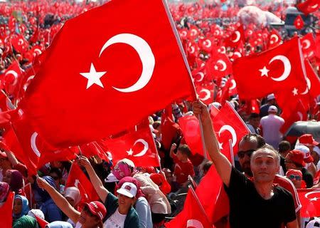 A man waves Turkey's national flag during the Democracy and Martyrs Rally, organized by Turkish President Tayyip Erdogan and supported by ruling AK Party (AKP), oppositions Republican People's Party (CHP) and Nationalist Movement Party (MHP), to protest against last month's failed military coup attempt, in Istanbul, Turkey, August 7, 2016. REUTERS/Osman Orsal