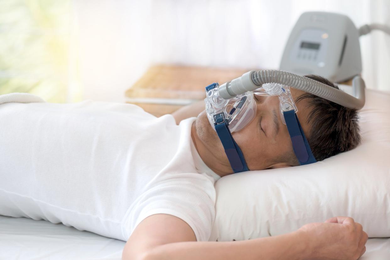 Man wearing a sleep apnea machine