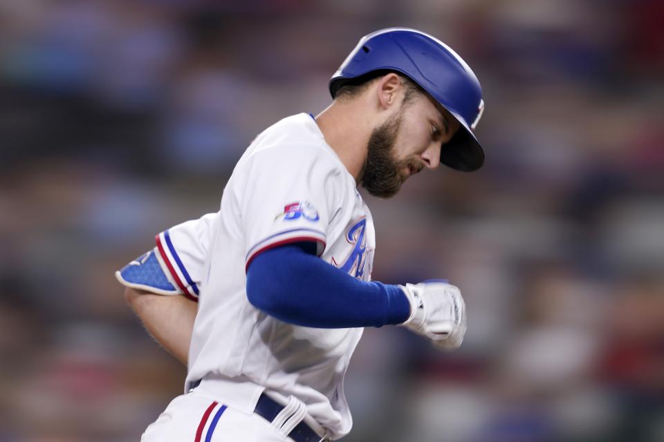 Texas Rangers' Eli White rounds third on his way home after hitting a two-run home run on a pitch from Tampa Bay Rays starter Drew Rasmussen in the second inning of a baseball game, Monday, May 30, 2022, in Arlington, Texas. The shot also scored Josh Smith. (AP Photo/Tony Gutierrez)