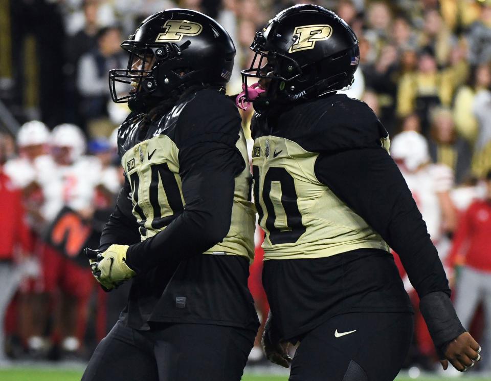 Oct 15, 2022; West Lafayette, Indiana, USA; Purdue Boilermakers defensive end Kydran Jenkins (44) celebrates with Purdue Boilermakers defensive tackle Lawrence Johnson (90) after a sack during the first half at Ross-Ade Stadium. Mandatory Credit: Robert Goddin-USA TODAY Sports