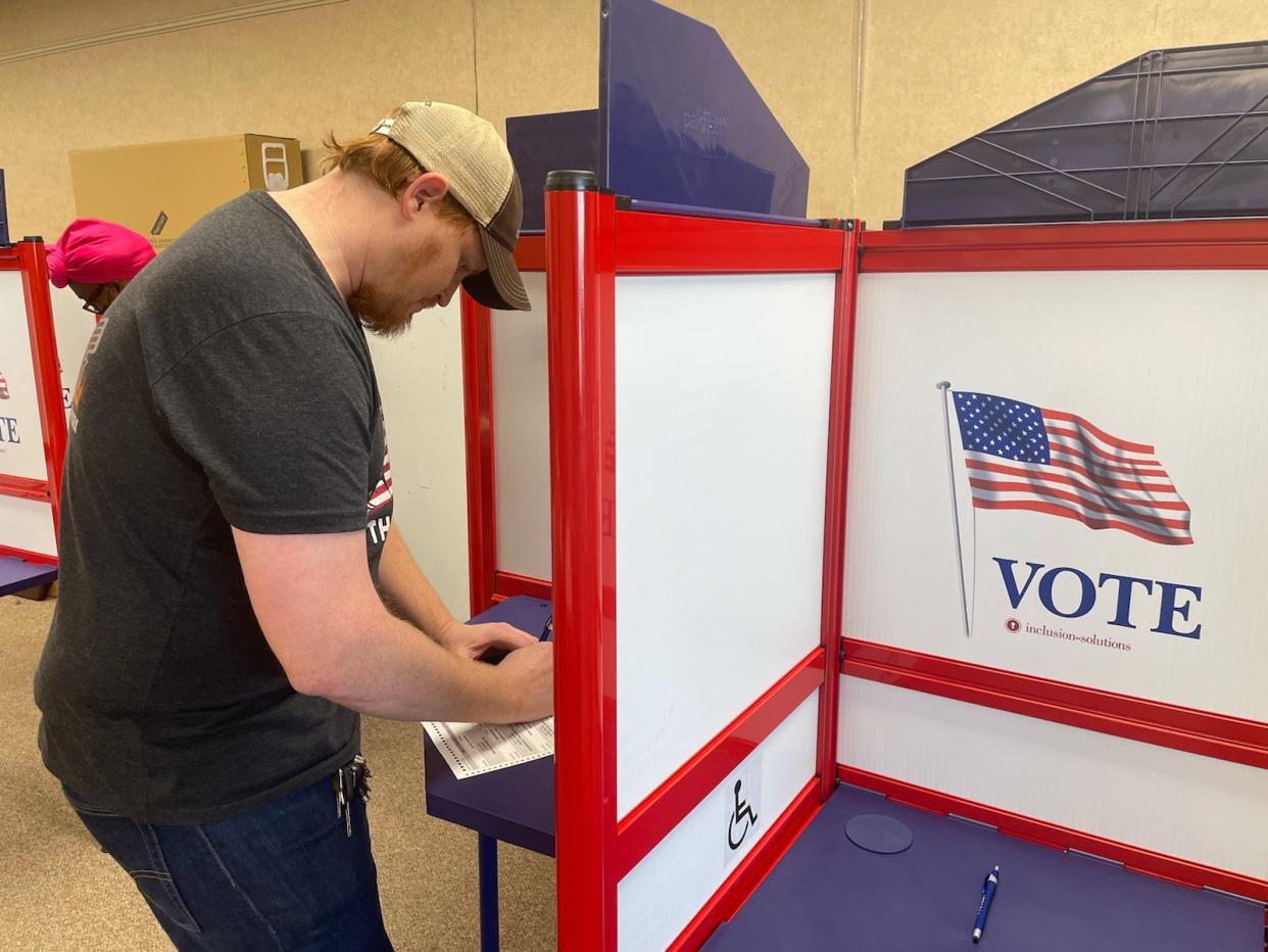 Mark Bell of Crystal Springs makes his voting selections at the J.T. Biggs, Jr. Memorial Library in Crystal Springs where turnout was strong with about 20% of those registered at the precinct voting by just afternoon in Tuesday's general election.