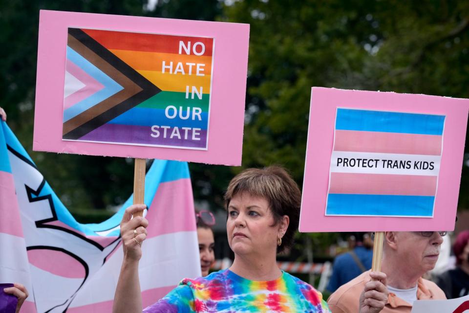 Martha Young of Coventry joins others outside the William Hall Library in Cranston to protest an anti-transgender forum there on Monday night.