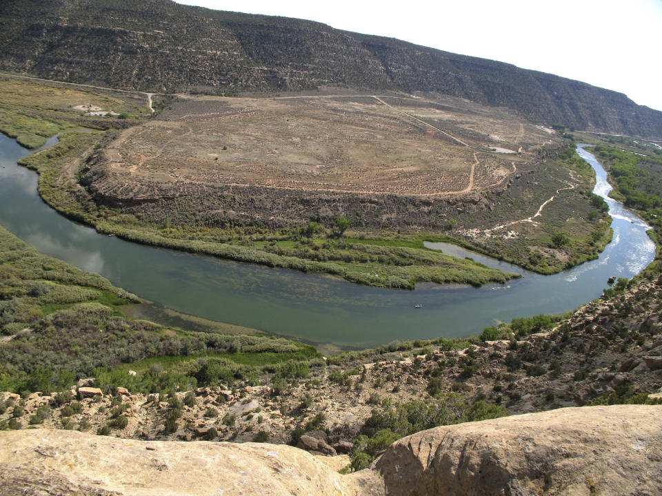 FILE - A guide boat float down the San Juan River below Navajo Dam, N.M., on Sept. 14, 2008. . A Native American tribe has agreed to lease more of its water to help address dwindling supplies in the Colorado River Basin. The agreement involves the Jicarilla Apache Nation, the New Mexico Interstate Stream Commission and The Nature Conservancy. The water would be released from the Navajo Reservoir in northwestern New Mexico to feed the San Juan River, which flows into the Colorado River. (AP Photo/Susan Montoya Bryan, File)