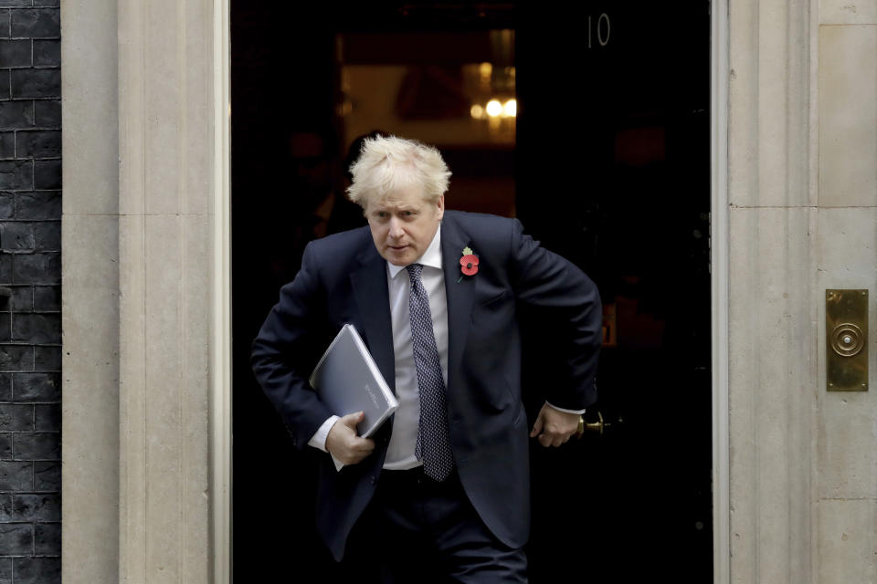 FILE - In this Tuesday, Nov. 10, 2020 file photo, British Prime Minister Boris Johnson leaves 10 Downing Street in London, to attend a weekly cabinet meeting at the Foreign, Commonwealth & Development Office, in London. With major COVID-19 vaccines showing high levels of protection, British officials are cautiously — and they stress cautiously — optimistic that life may start returning to normal by early April. Even before regulators have approved a single vaccine, the U.K. and countries across Europe are moving quickly to organize the distribution and delivery systems needed to inoculate millions of citizens. (AP Photo/Matt Dunham, File)