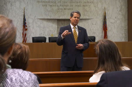 Georgia Secretary of State Brian Kemp speaks with visitors to the state capitol about the "SEC primary" involving a group of southern states voting next month in Atlanta, Georgia February 24, 2016. REUTERS/Letitia Stein