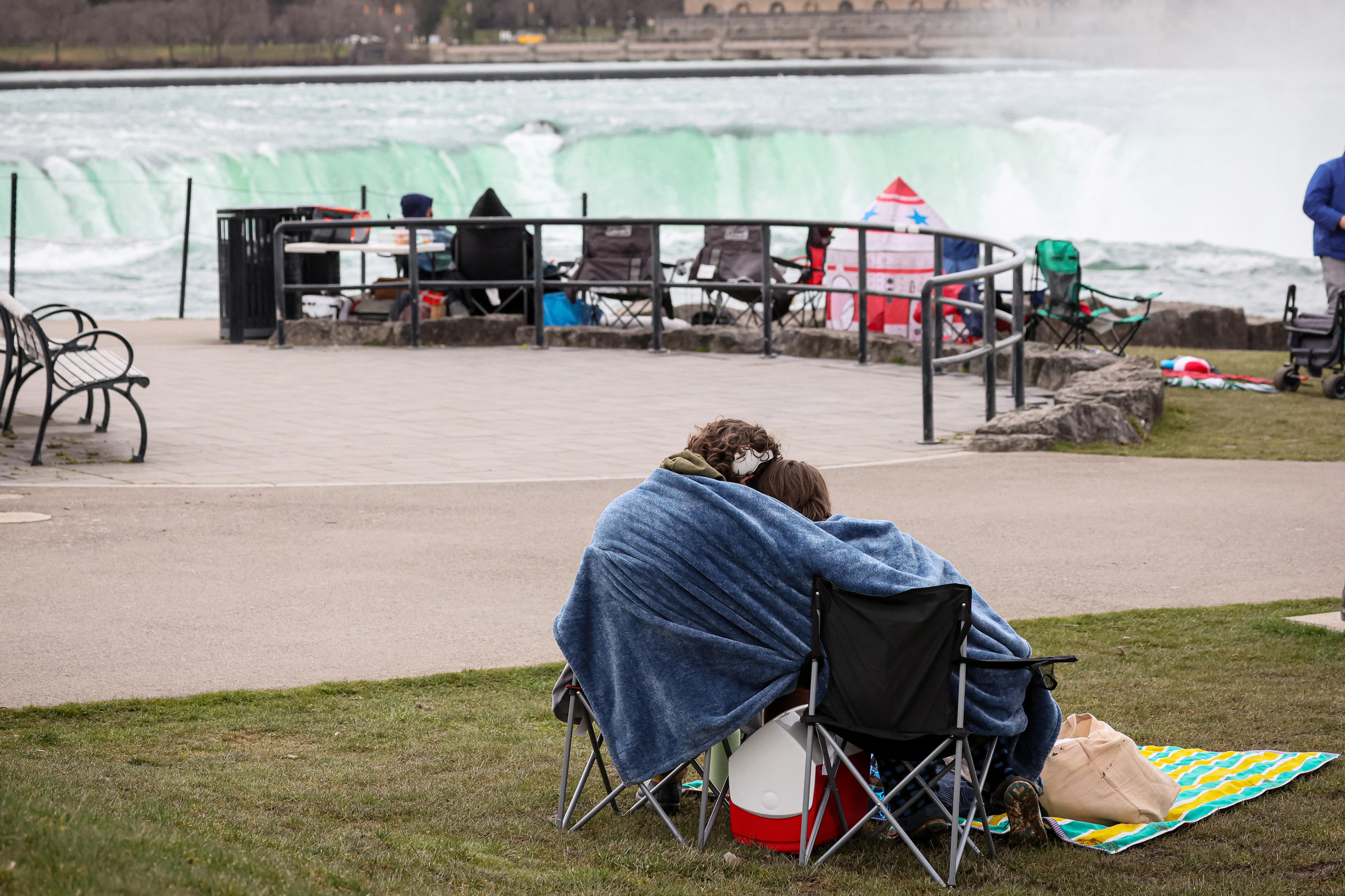 Tourists sleep next to the Horseshoe Falls, ahead of the Solar Eclipse that will take place across parts of the United States and Canada, at Niagara Falls, New York, U.S., April 8, 2024. (Brendan McDermid/Reuters)