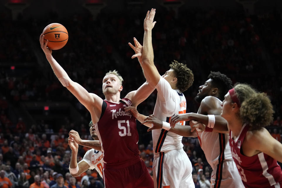 Nebraska's Rienk Mast scores past Illinois' Coleman Hawkins during overtime in an NCAA college basketball game Sunday, Feb. 4, 2024, in Champaign, Ill. (AP Photo/Charles Rex Arbogast)
