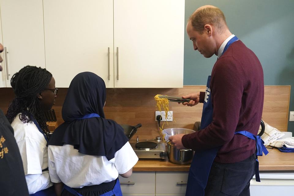 The Prince of Wales takes part in a cooking lesson during his visit to Together as One (until recently known as Aik Saath) in Slough