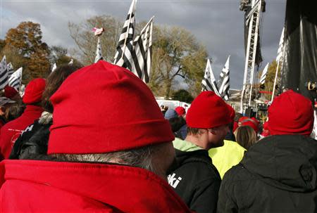 Protesters wearing red caps, the symbol of protest in Brittany take part in a demonstration to maintain jobs in the region and against an "ecotax" on commercial trucks, in Carhaix, western France, November 30, 2013. REUTERS/Mal Langsdon