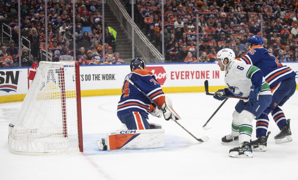 Vancouver Canucks' Brock Boeser (6) scores on Edmonton Oilers goalie Stuart Skinner (74) during the first period of Game 3 of an NHL hockey Stanley Cup second-round playoff series in Edmonton, Alberta, Sunday, May 12, 2024. (Jason Franson/The Canadian Press via AP)