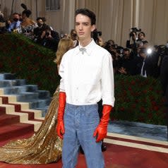 Kodi Smit McPhee in jeans and red gloves