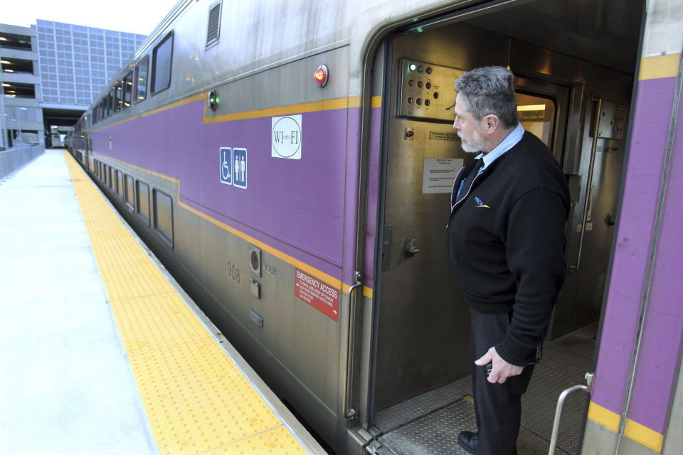 FILE - In this April 1, 2011 file photo, MBTA conductor James Moriarty looks out as a train leaves the T.F. Green Airport station in Warwick, R.I., heading to Boston. More passengers are using the commuter rail line between Providence and Rhode Island’s main airport, transportation officials reported Friday, April 6, 2012, but not as many as was hoped when the trains started rolling in late 2010. The MBTA said ridership statistics 14 months after the service began show an average of 149 people take the train to the airport each weekday, and 177 people ride outbound. (AP Photo/Stew Milne, File)