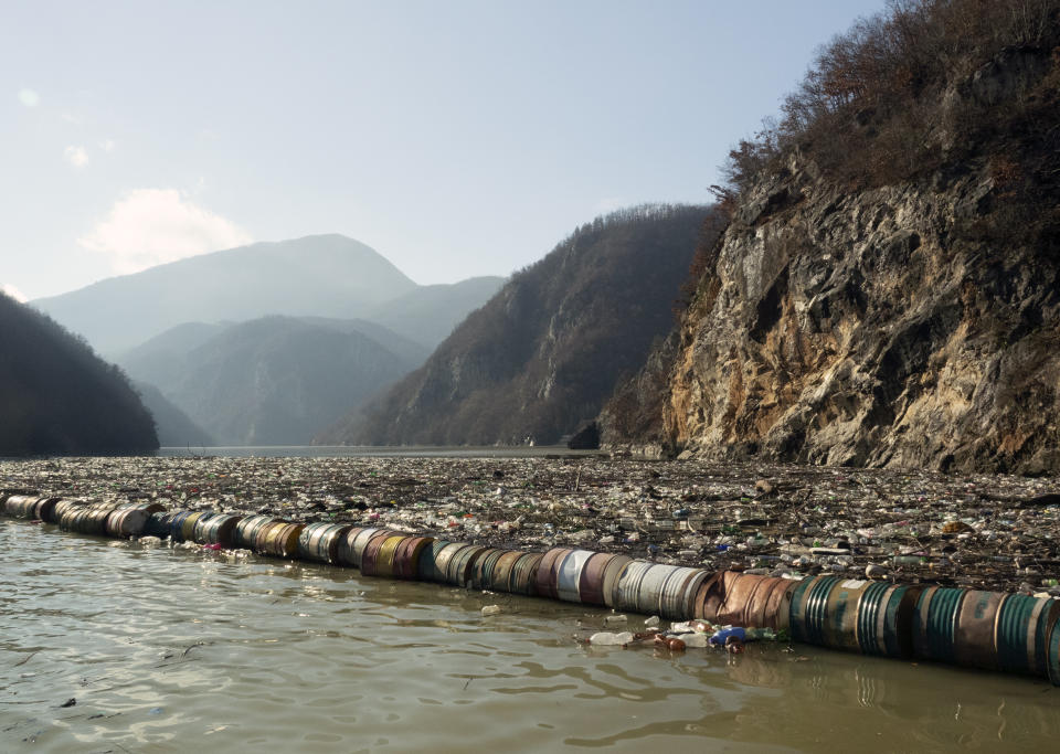 Plastic bottles, wooden planks, rusty barrels and other garbage clogging the Drina river near the eastern Bosnian town of Visegrad, Bosnia, Tuesday, Jan. 5, 2021. Further upstream, the Drina tributaries in Montenegro, Serbia and Bosnia are carrying even more waste after the swollen rivers surged over the the landfills by their banks. The Balkan nations have poor waste management and tons of garbage routinely end up in rivers. (AP Photo/Eldar Emric)