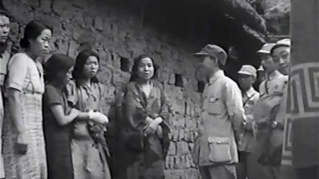 Seven 'comfort women' are seen standing next to a Chinese soldier during World War II. Source:  US National Archives