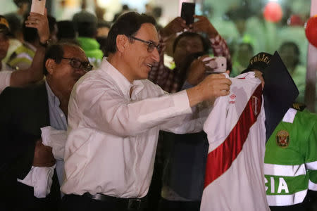 Peru's Vice President Martin Vizcarra receives a gift as he arrives in Lima, Peru, March 23, 2018. REUTERS/Guadalupe Pardo