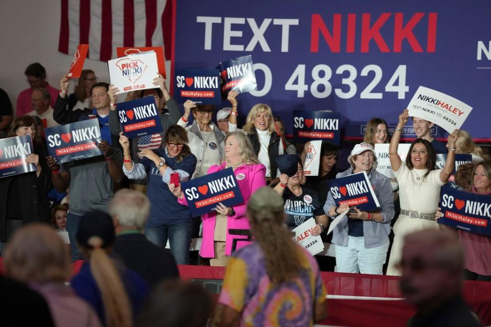 Supporters wave signs ahead of a campaign event for GOP presidential hopeful Nikki Haley on Monday, Nov. 27, 2023, in Bluffton, S.C. Haley is among a cluster of Republican candidates competing for second place in a GOP Republican primary thus far largely dominated by former President Donald Trump. (AP Photo/Meg Kinnard) ORG XMIT: SCMK102