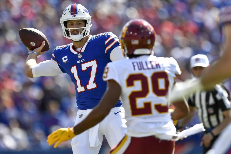 Buffalo Bills quarterback Josh Allen looks to pass while pressured by Washington Football Team cornerback Kendall Fuller.