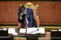 FILE - In this Wednesday, Dec. 9, 2020 file photo, Italian Premier Giuseppe Conte touches his forehead as he takes a break while addressing the Senate in Rome. When Giuseppe Conte exited the premier’s office, palace employees warmly applauded in him appreciation. But that’s hardly likely to be Conte’s last hurrah in politics. Just a few hours after the handover-ceremony to transfer power to Mario Draghi, the former European Central Bank chief now tasked with leading Italy in the pandemic, Conte dashed off a thank-you note to citizens that sounded more like an ’’arrivederci″ (see you again) then a retreat from the political world he was unexpectedly propelled into in 2018.(Mauro Scrobogna/LaPresse via AP)