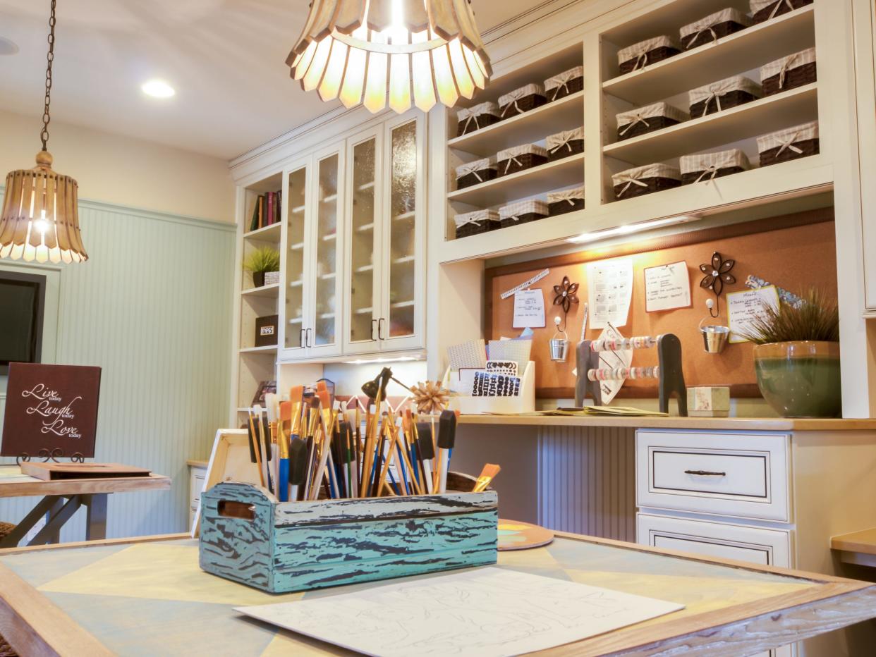 A combination of open and hidden storage, a vision board, and tools at hand help crafters unleash their inner artists at home.