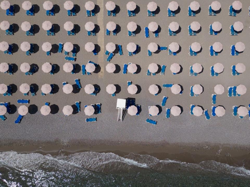 Empty sun loungers line the beach at a resort on July 29, 2023 in Lardos, Rhodes, Greece