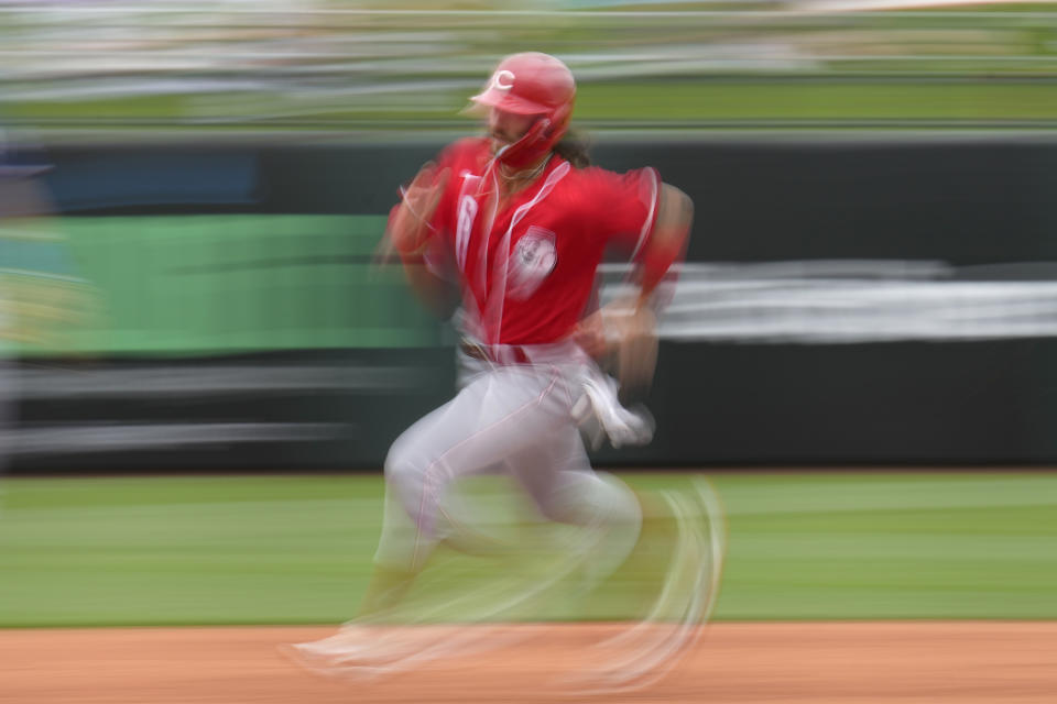 Cincinnati Reds second baseman Jonathan India runs home to score off an RBI-double by Jake Fraley during the fifth inning of a spring training baseball game against the Texas Rangers, Saturday, March 11, 2023, in Surprise, Ariz. (AP Photo/Abbie Parr)