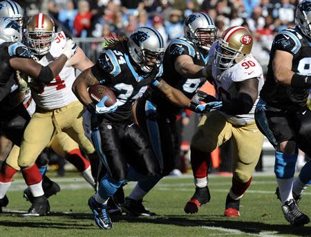 Jan 12, 2014; Charlotte, NC, USA; Carolina Panthers running back DeAngelo Williams (34) runs against San Francisco 49ers nose tackle Glenn Dorsey (90) during the third quarter of the 2013 NFC divisional playoff football game at Bank of America Stadium. Sam Sharpe-USA TODAY Sports