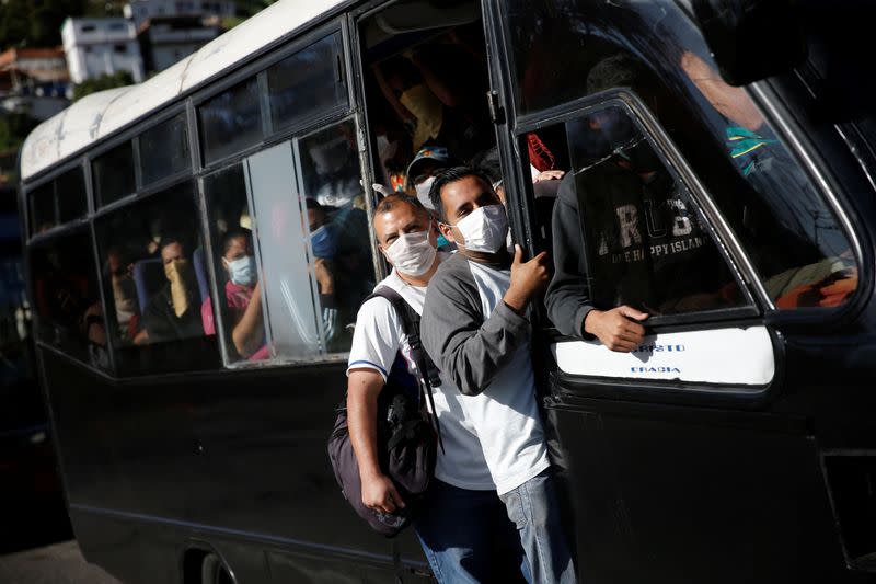 A crowded bus with people using protective masks passes through a checkpoint after the start of quarantine in response to the spreading of coronavirus disease (COVID-19) in Caracas