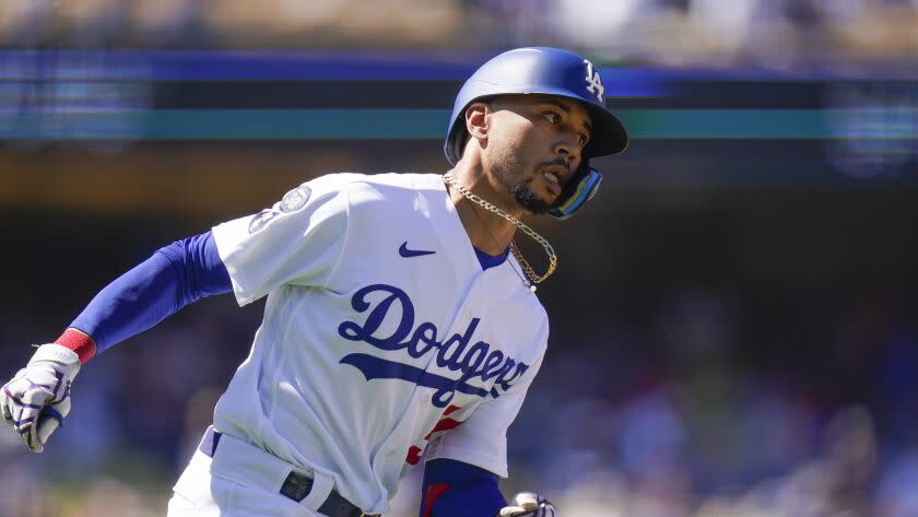 Los Angeles Dodgers' Mookie Betts runs to first base after hitting a fly ball during the second inning.