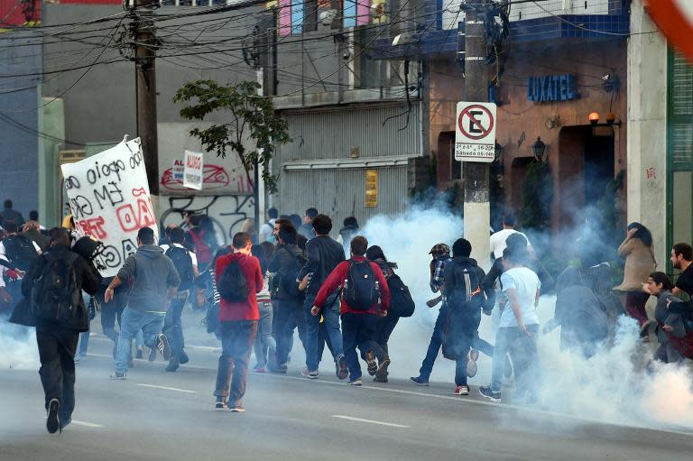 Striking subway workers are dispersed with tear gas by police as they demonstrate in Sao Paulo, Brazil on June 9, 2014